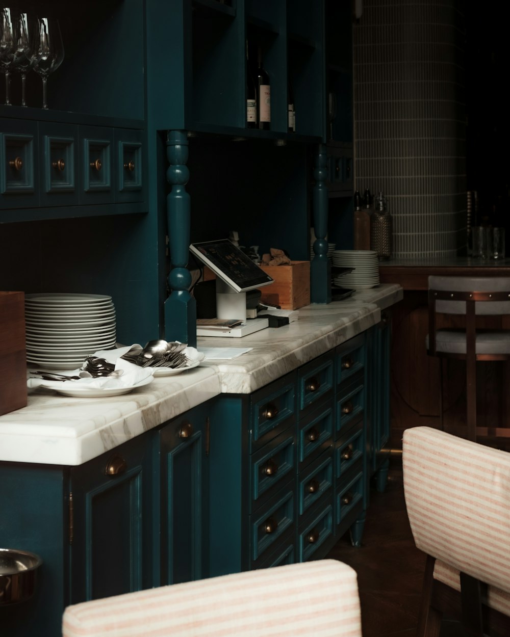 a kitchen with blue cabinets and white counter tops