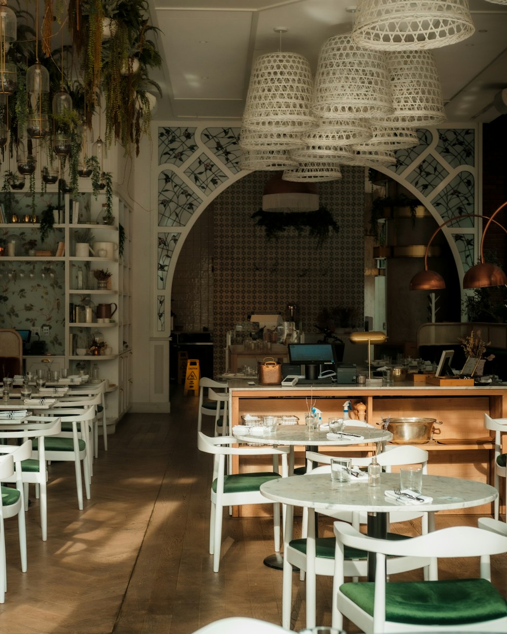 a restaurant with tables, chairs, and shelves