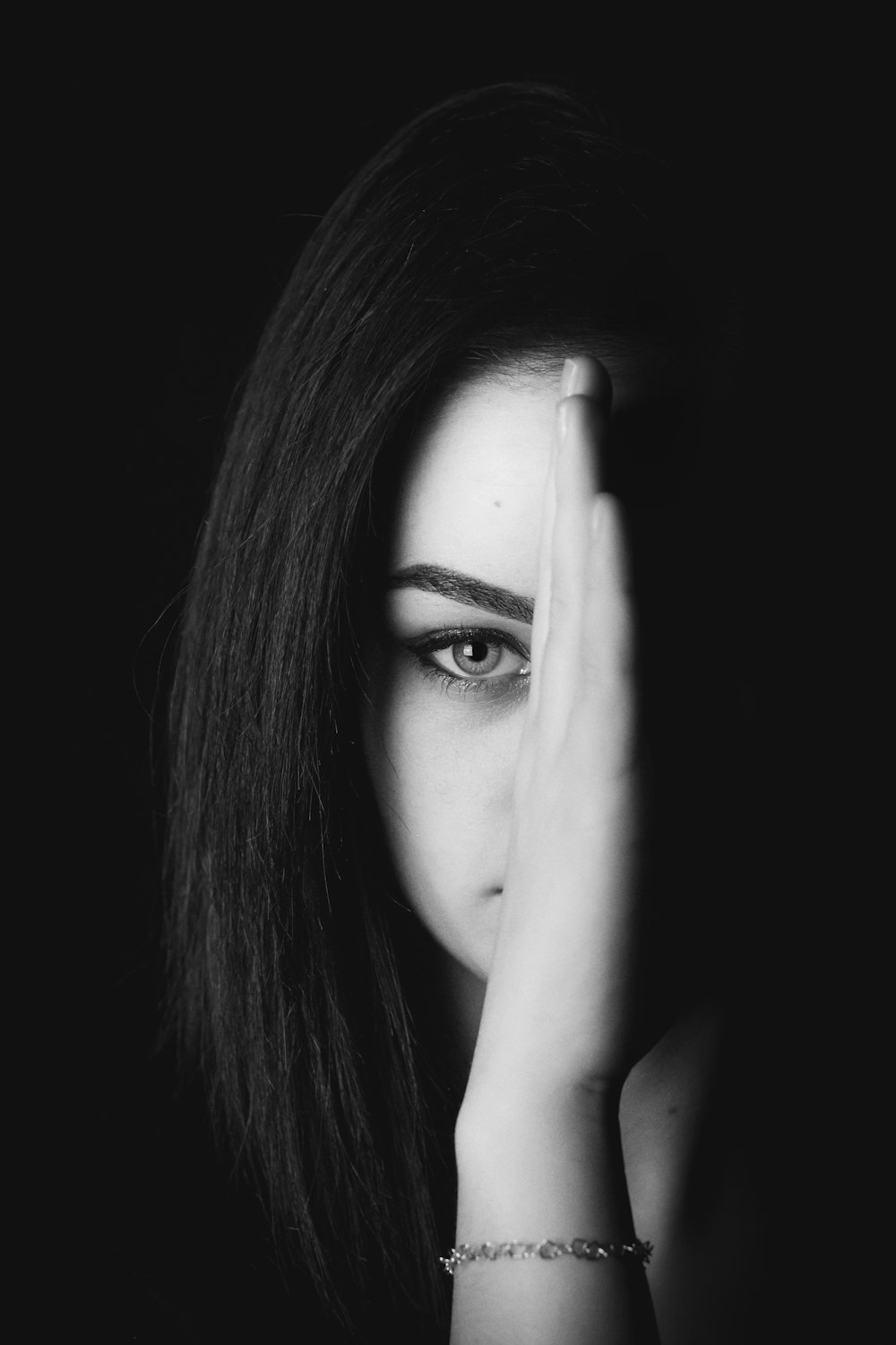 a woman covering her face with her hands