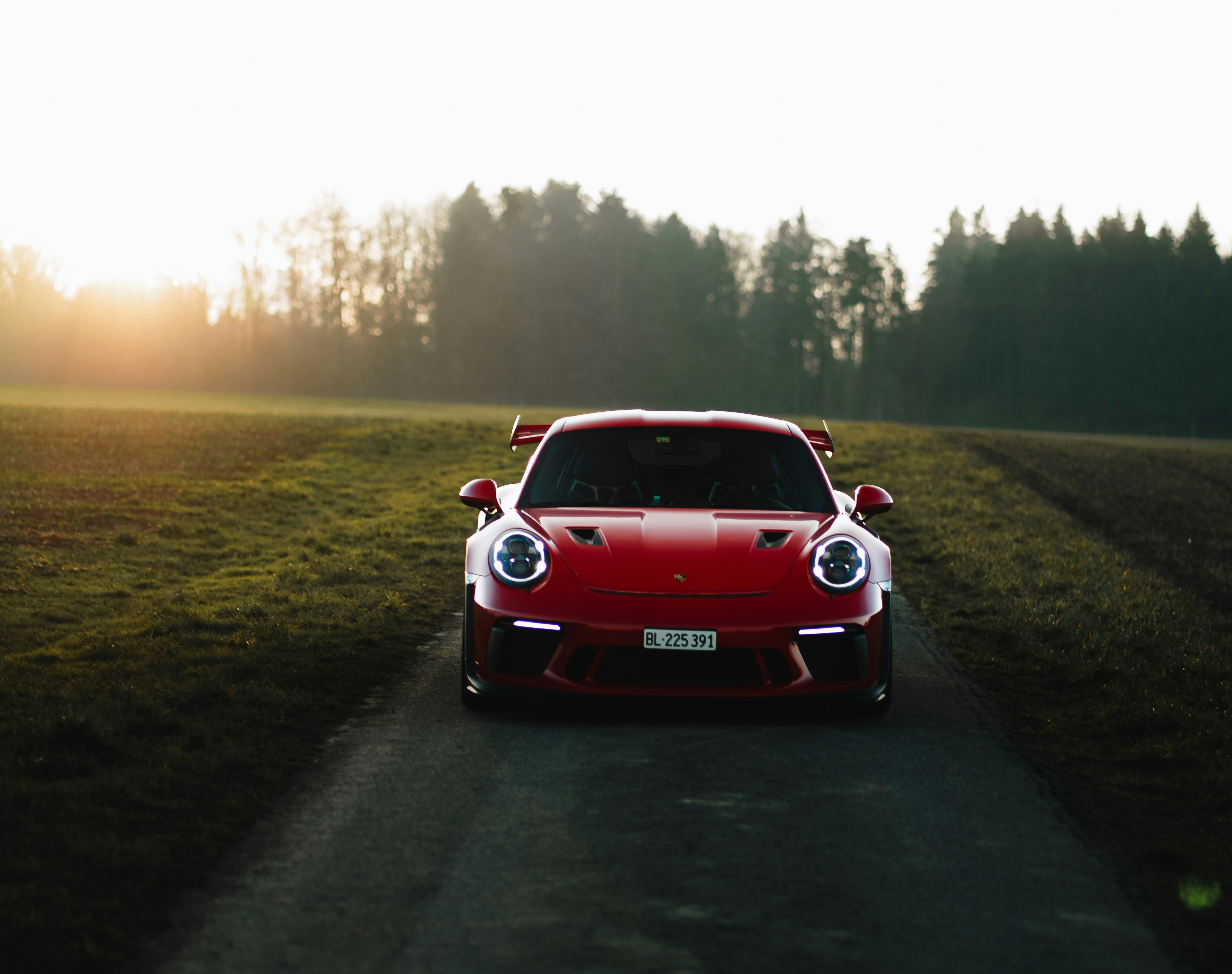 A red sports car driving down a country road photo – Free Switzerland ...