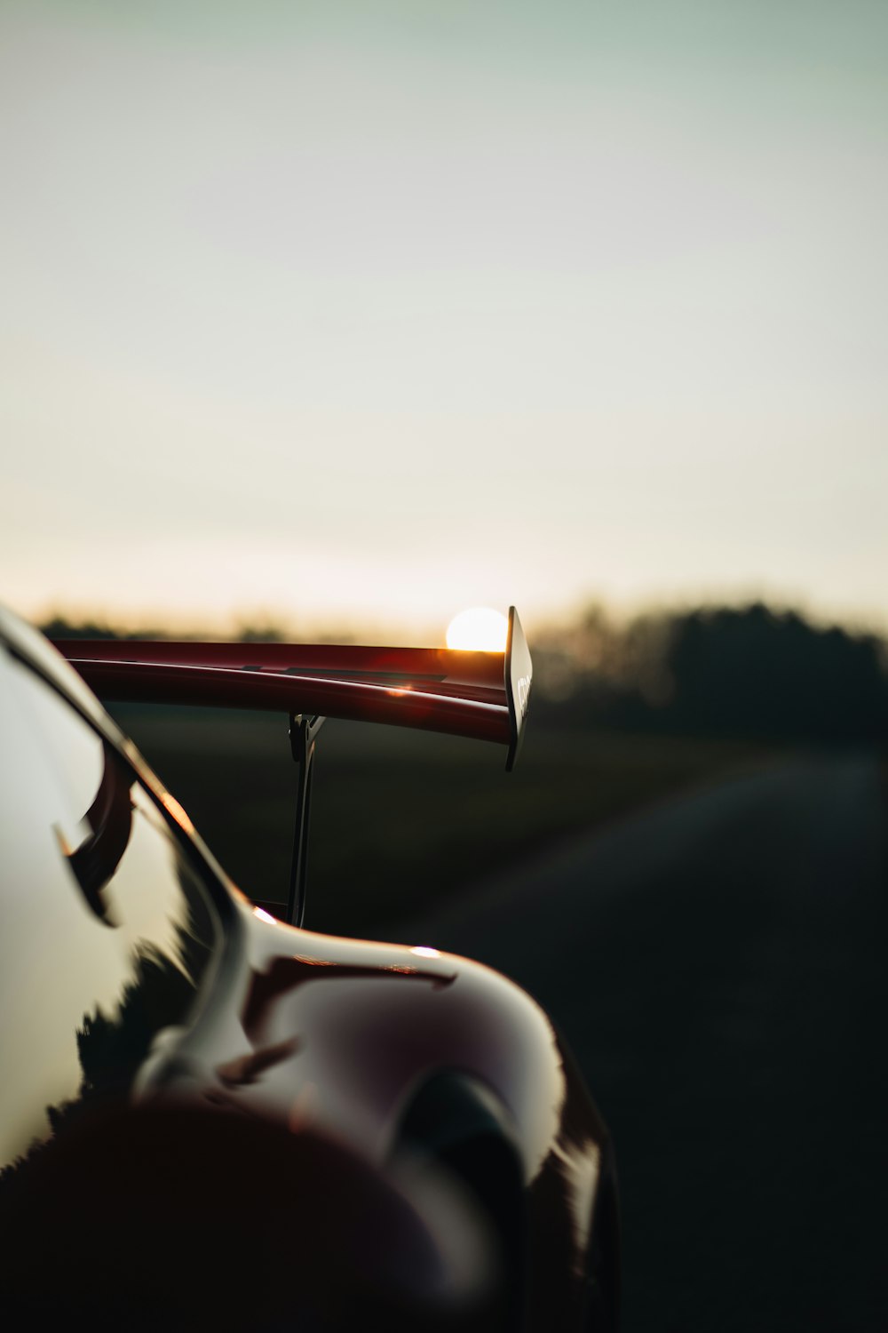 a close up of a car with the sun in the background