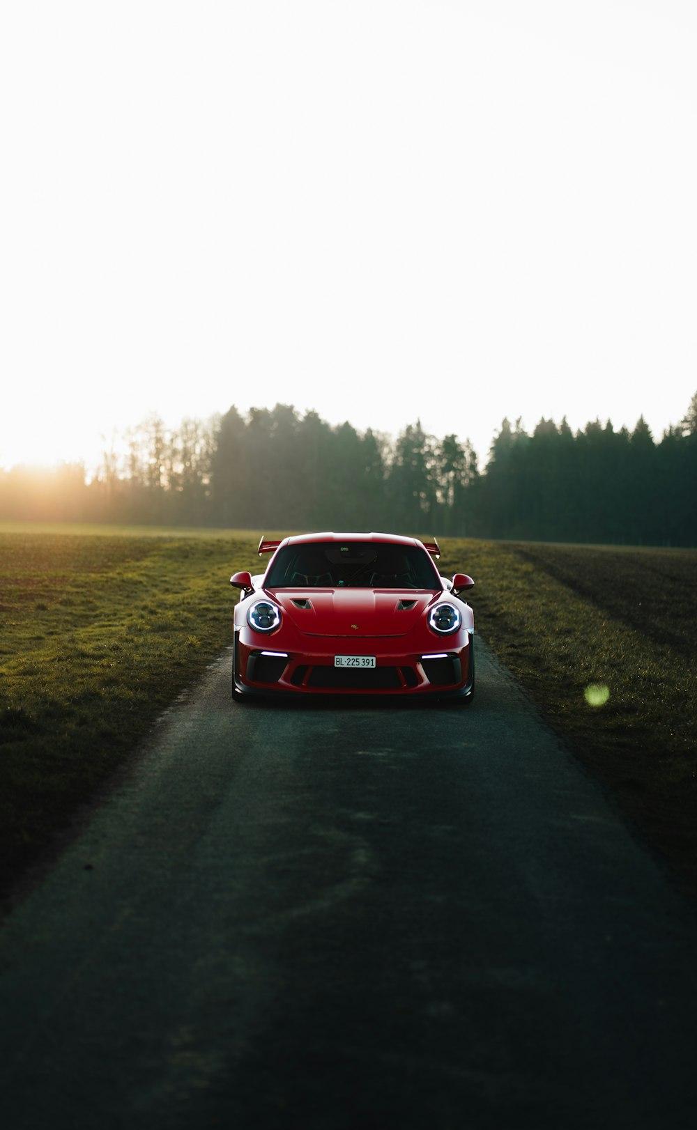 a red sports car parked on the side of a road