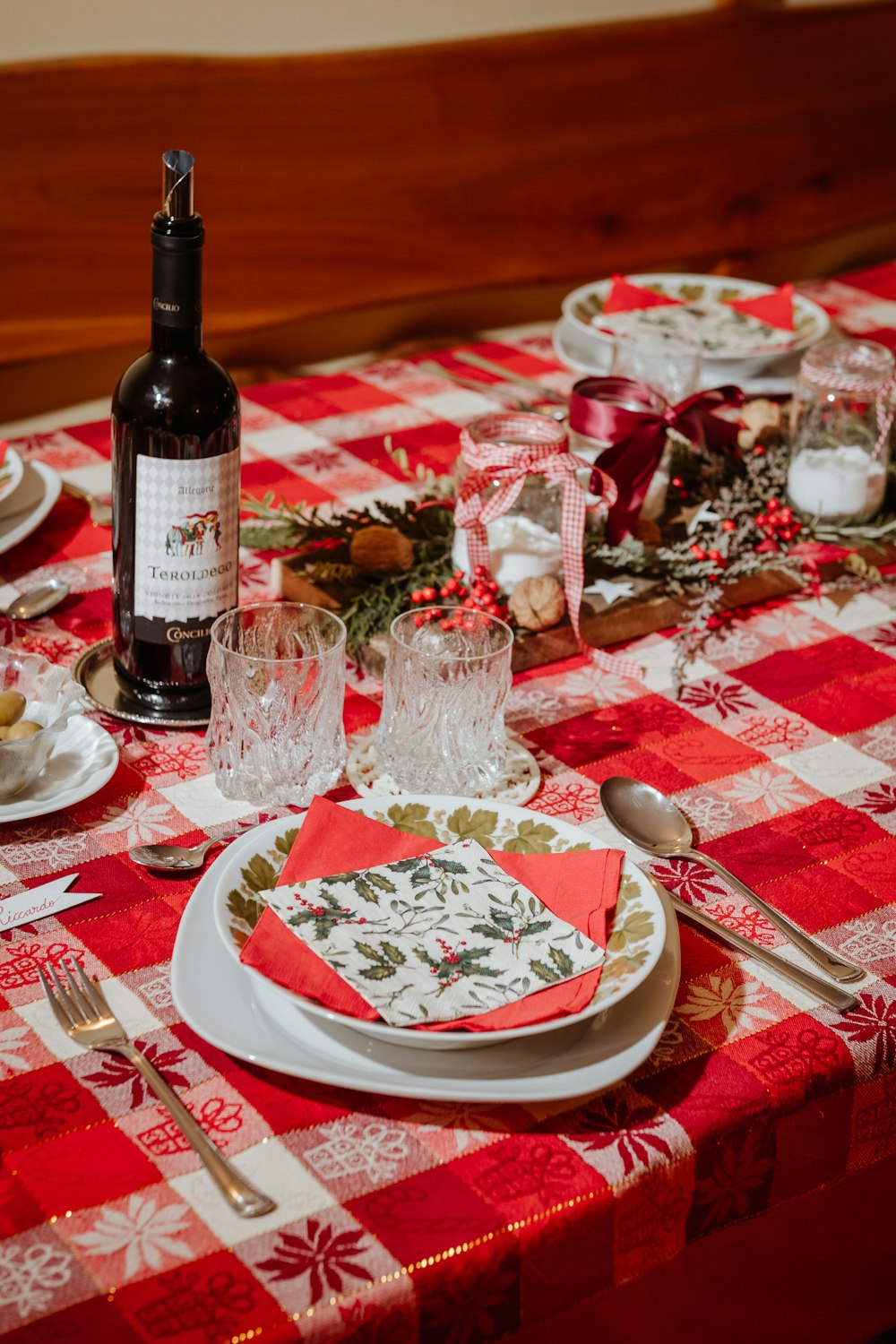 a red and white table with a bottle of wine