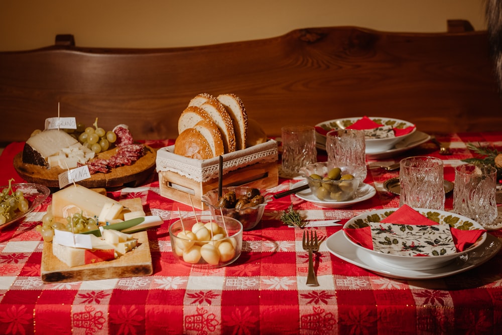 a table topped with plates and bowls of food