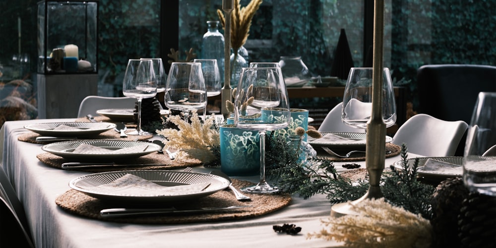 a table set for a formal dinner with place settings