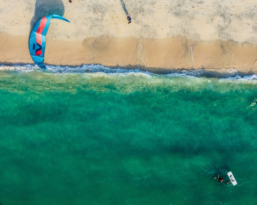 two people parasailing in the ocean on a sunny day