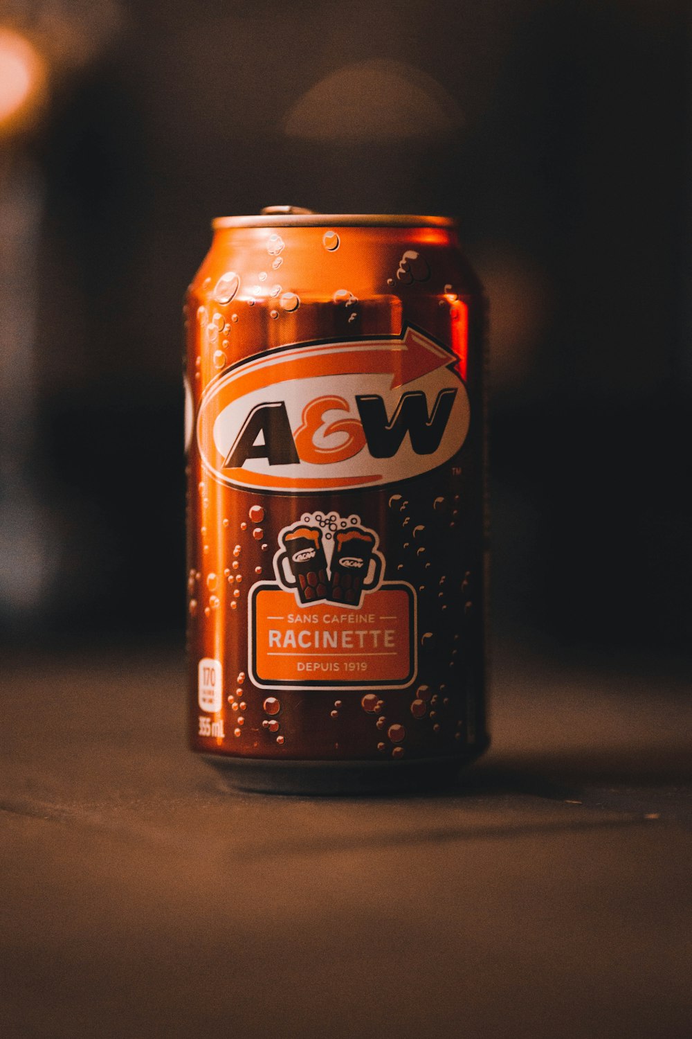 a close up of a can of beer on a table