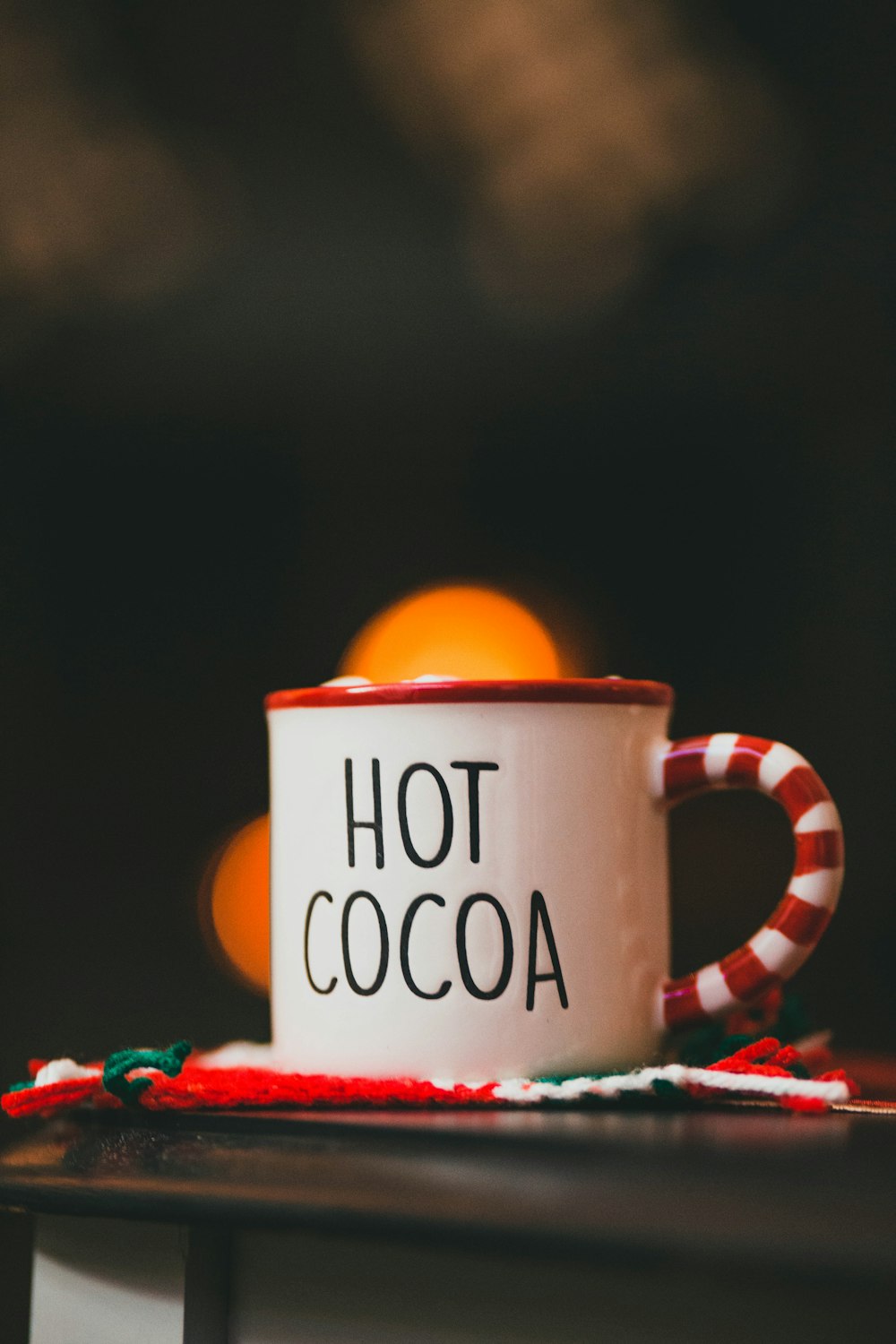 a red and white coffee cup sitting on top of a table