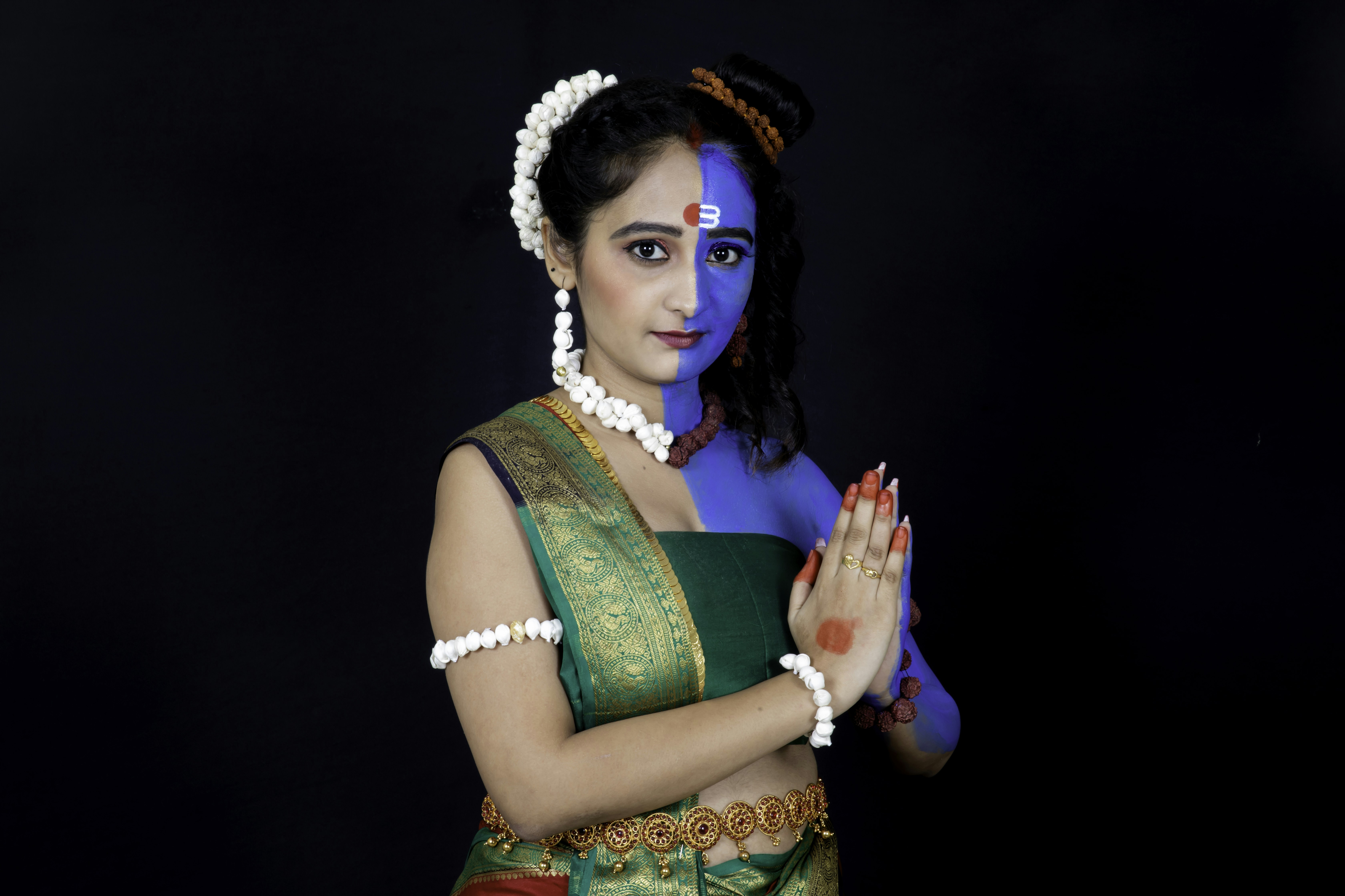 Woman in green and gold sari