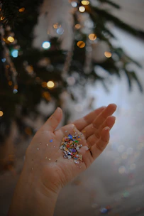 Close-up of hands holding colorful invitations with verdeviva branding at a festive event.
