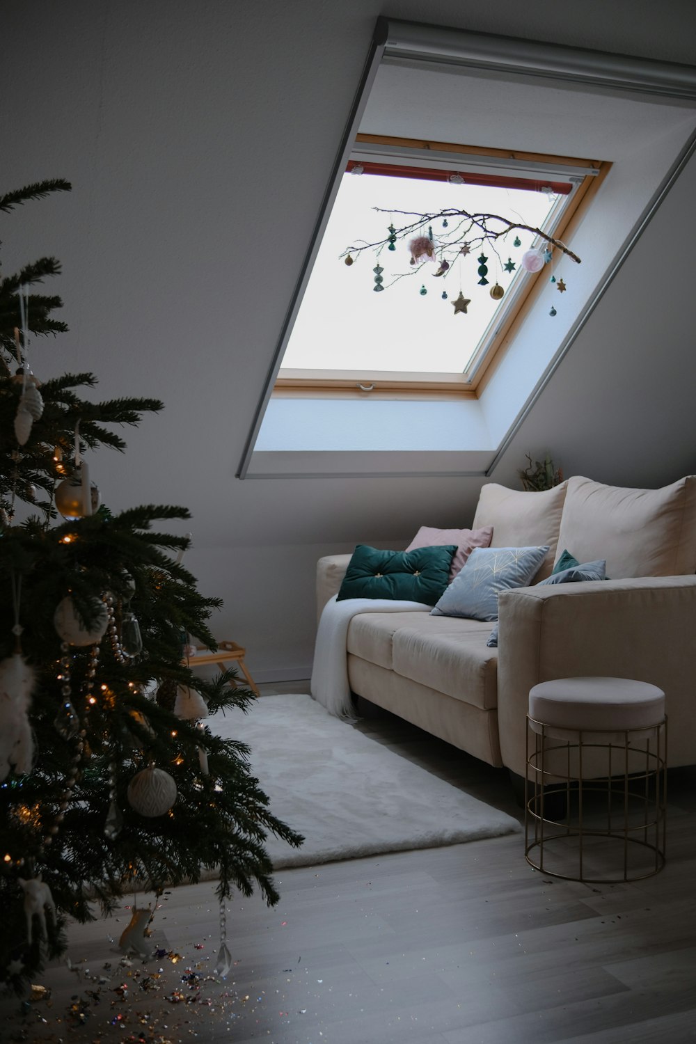 a living room with a couch and a christmas tree