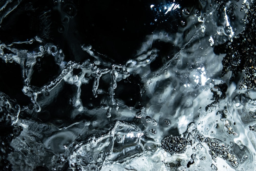 a black and white photo of water and ice