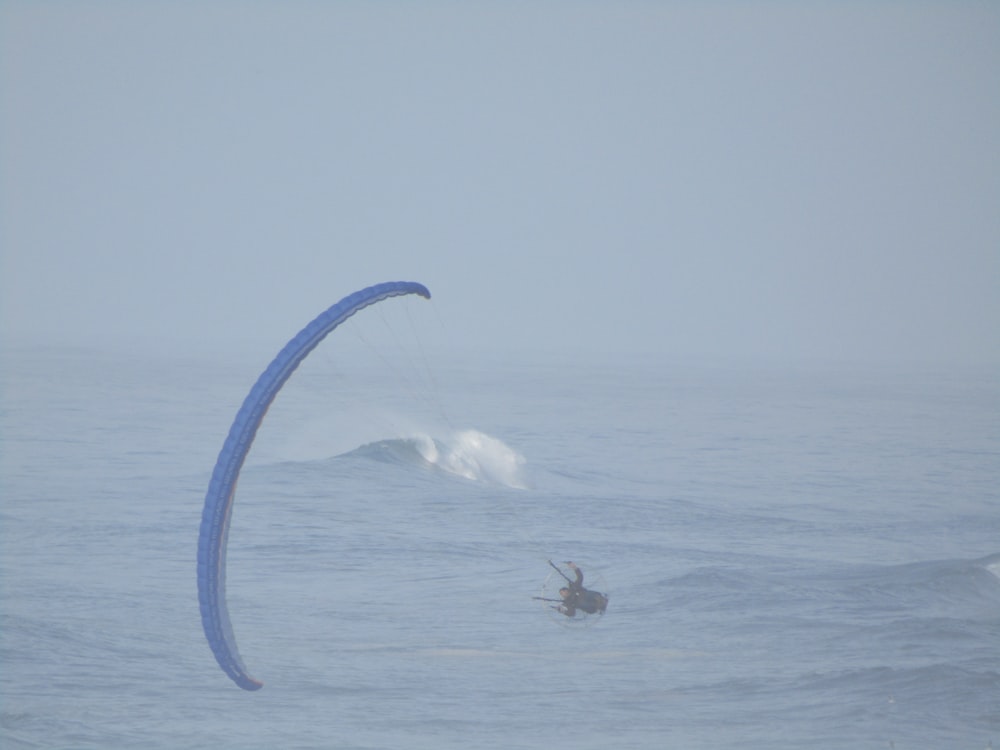 a person para sailing in the ocean on a foggy day