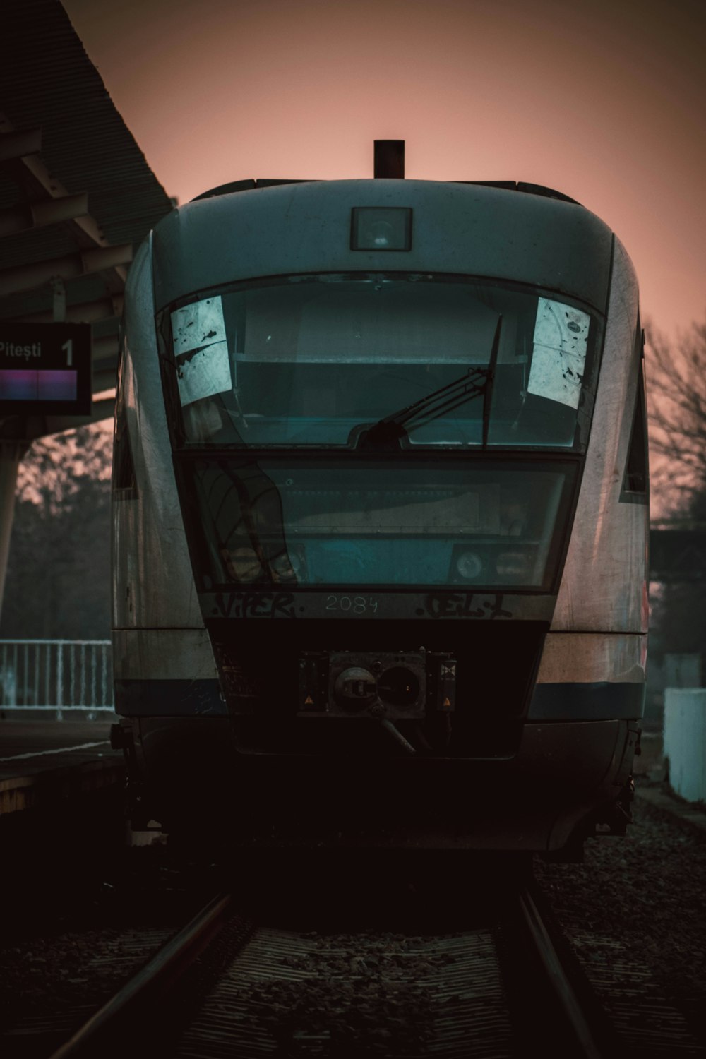 a train sitting on the tracks at a train station