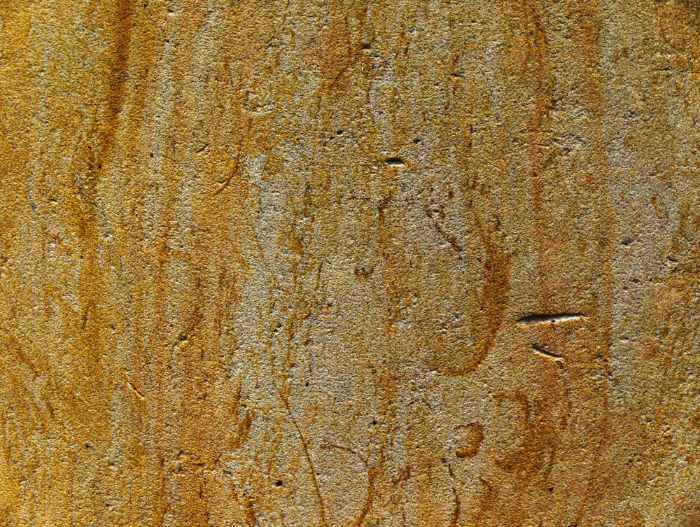 a close up of a wooden surface with small scratches