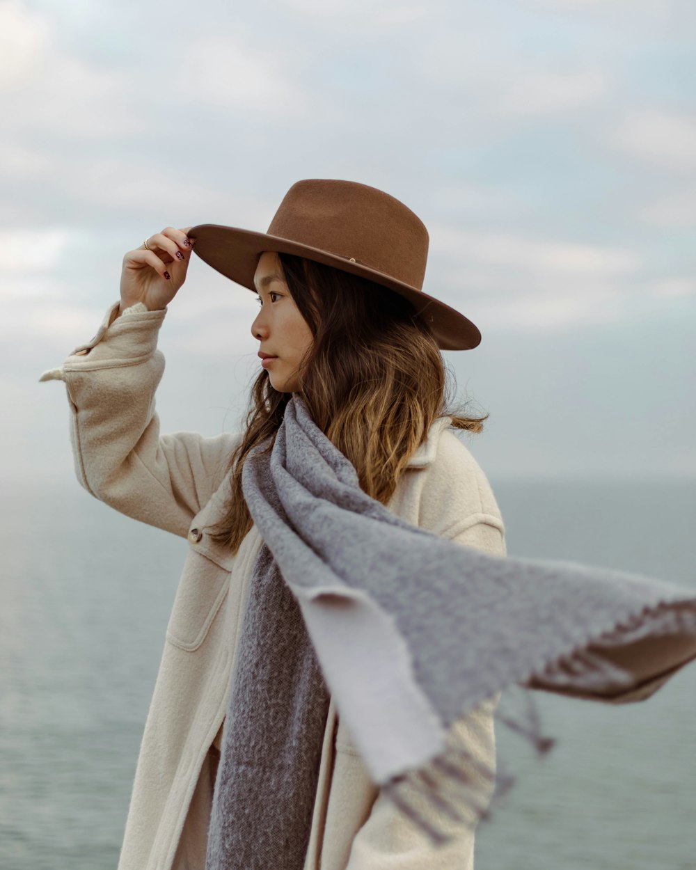 a woman wearing a hat and a scarf