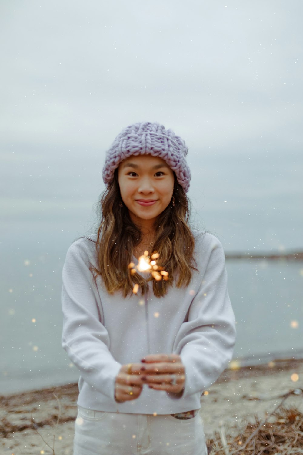 a woman holding a sparkler in her hands