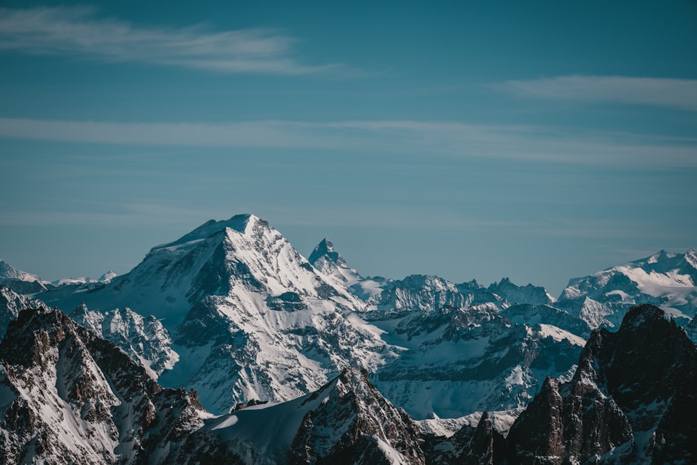 a mountain range with snow covered mountains in the background