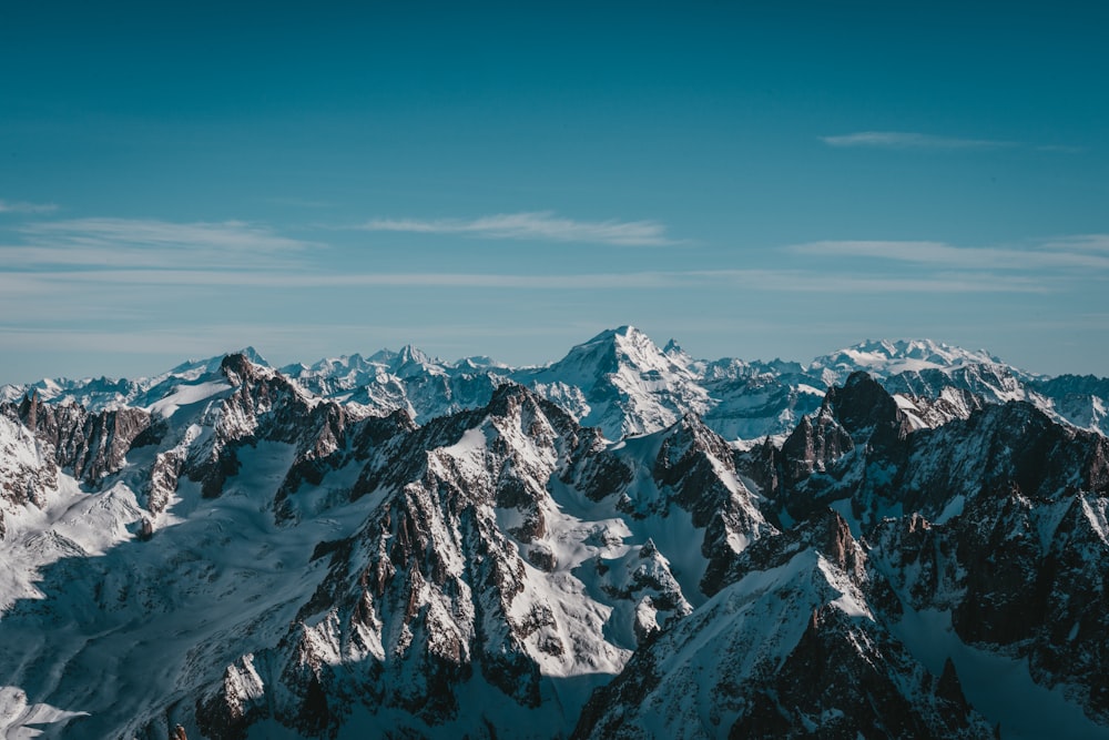 a mountain range with snow covered mountains in the background