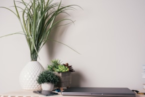 a laptop computer sitting on top of a wooden desk