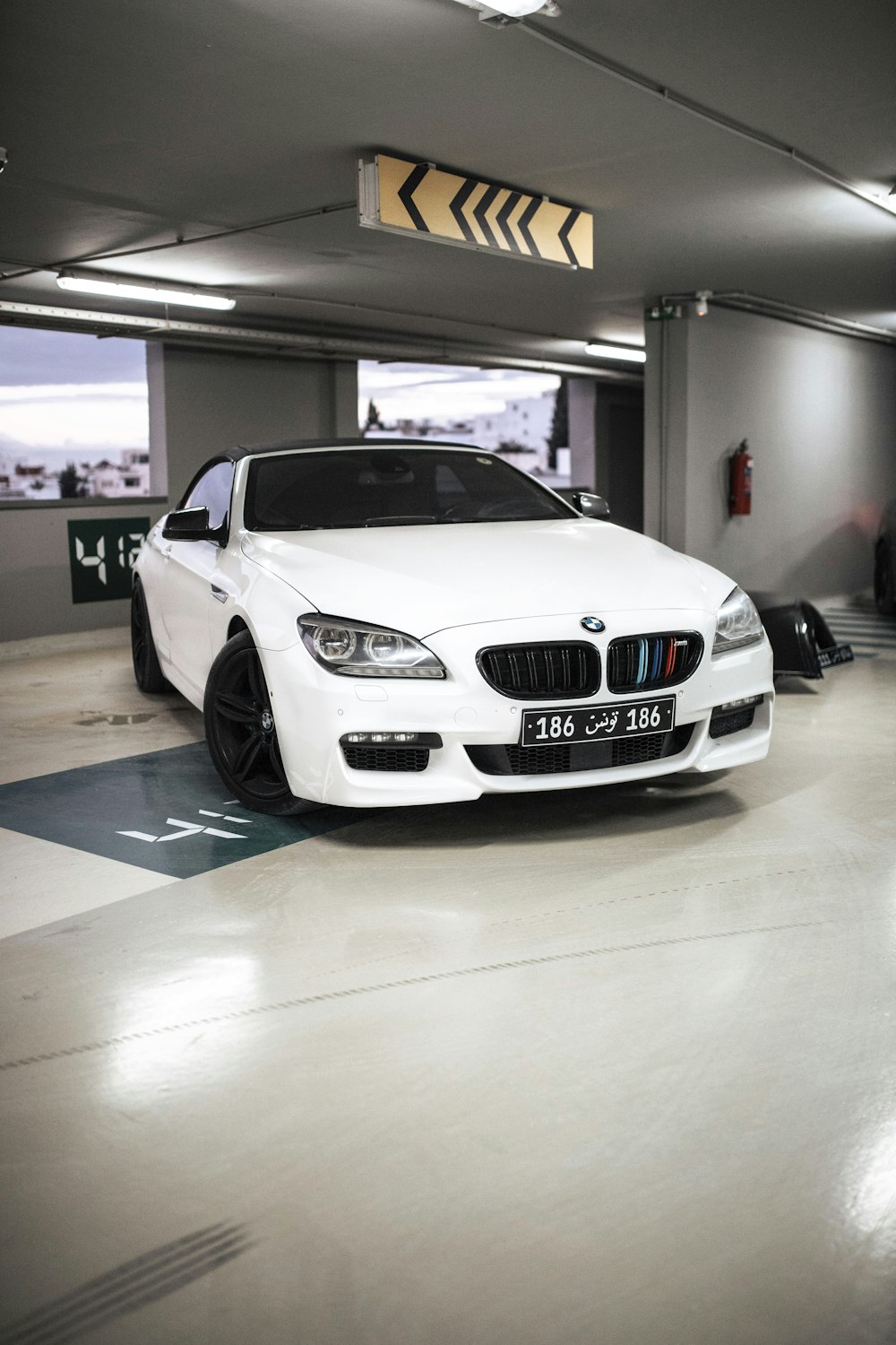 a white car parked in a parking garage