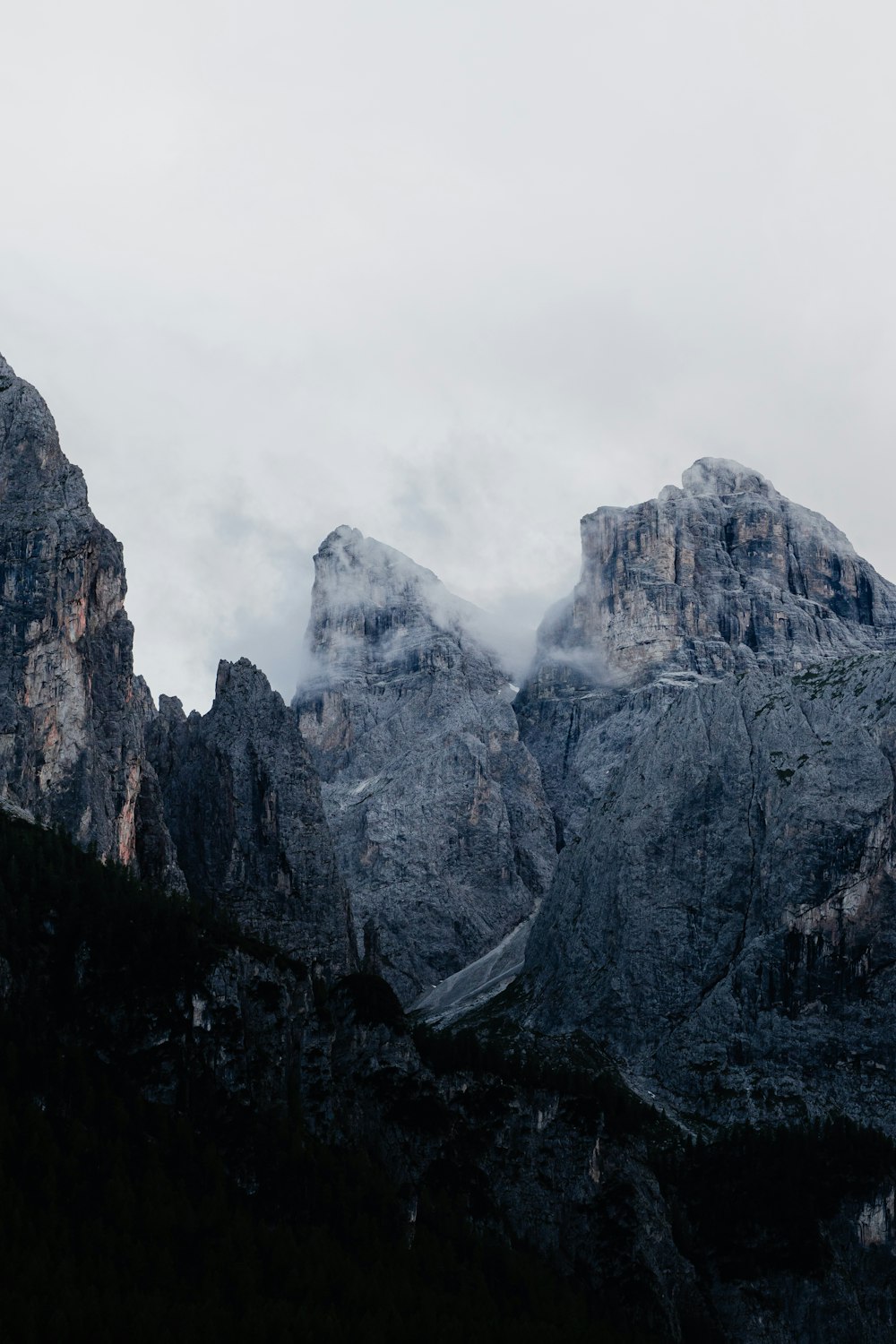 the mountains are covered in clouds and fog