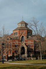a large red brick building with a clock tower