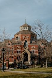 a large red brick building with a clock tower