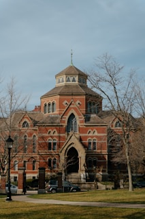 a large red brick building with a clock tower