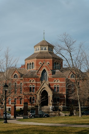 a large red brick building with a clock tower