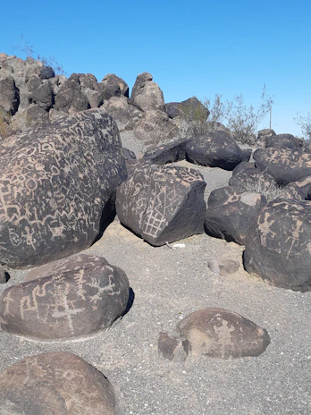 A serene landscape of sacred land with ancient rock art etched into stone.