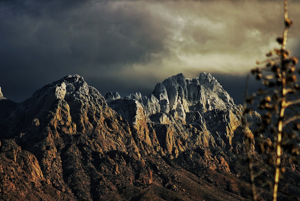 a view of a mountain range under a cloudy sky