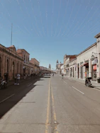 a street lined with buildings and people walking down it