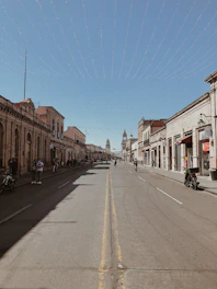 a street lined with buildings and people walking down it
