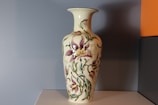 Close-up of a purple-themed handcrafted ceramic vase with delicate patterns.