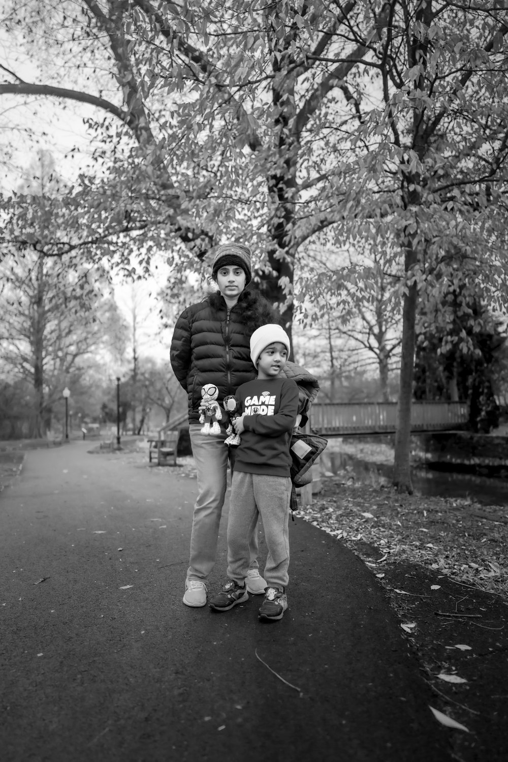 a woman and a child standing in a park