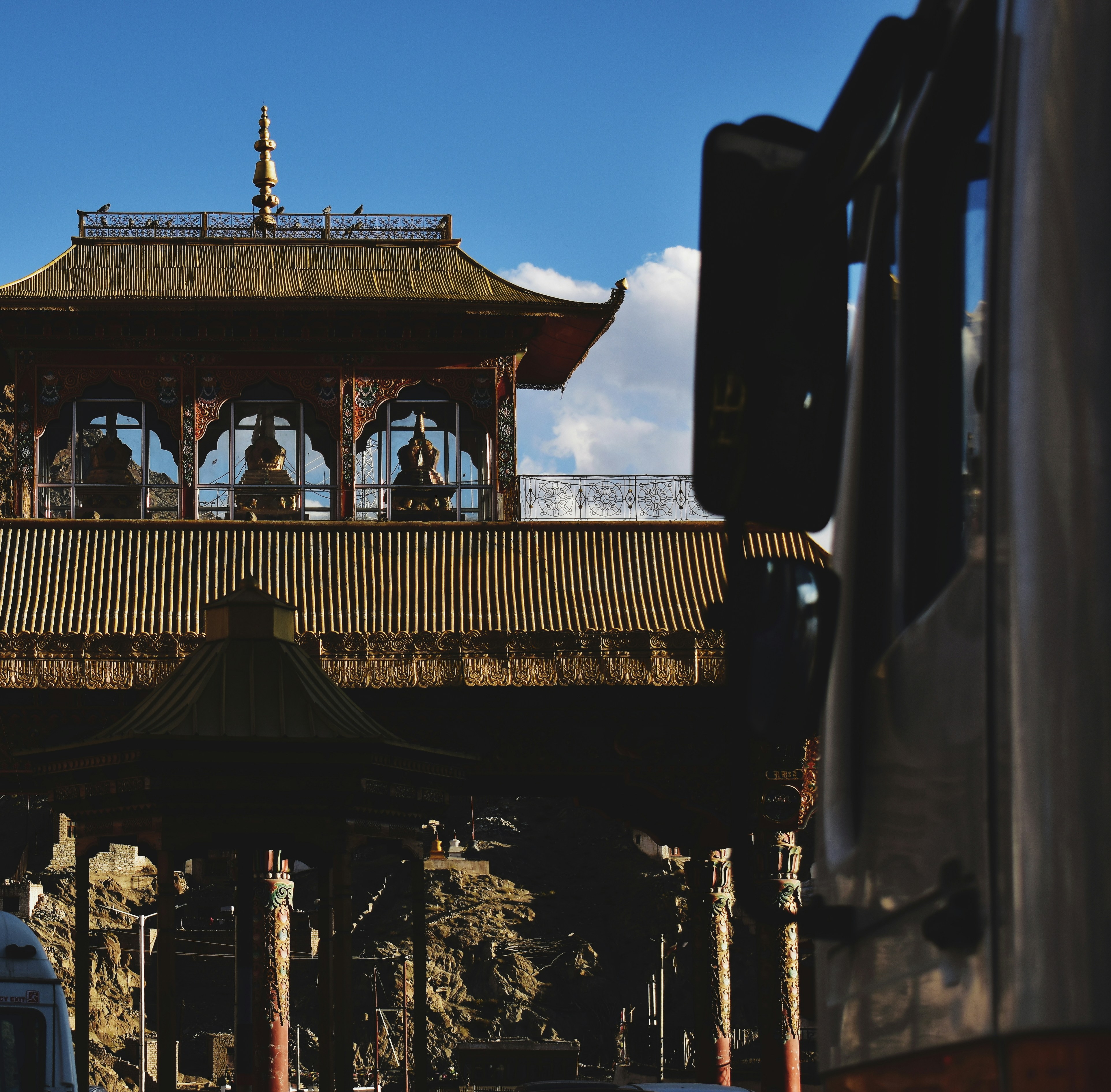 a tall wooden structure sitting on top of a lush green field