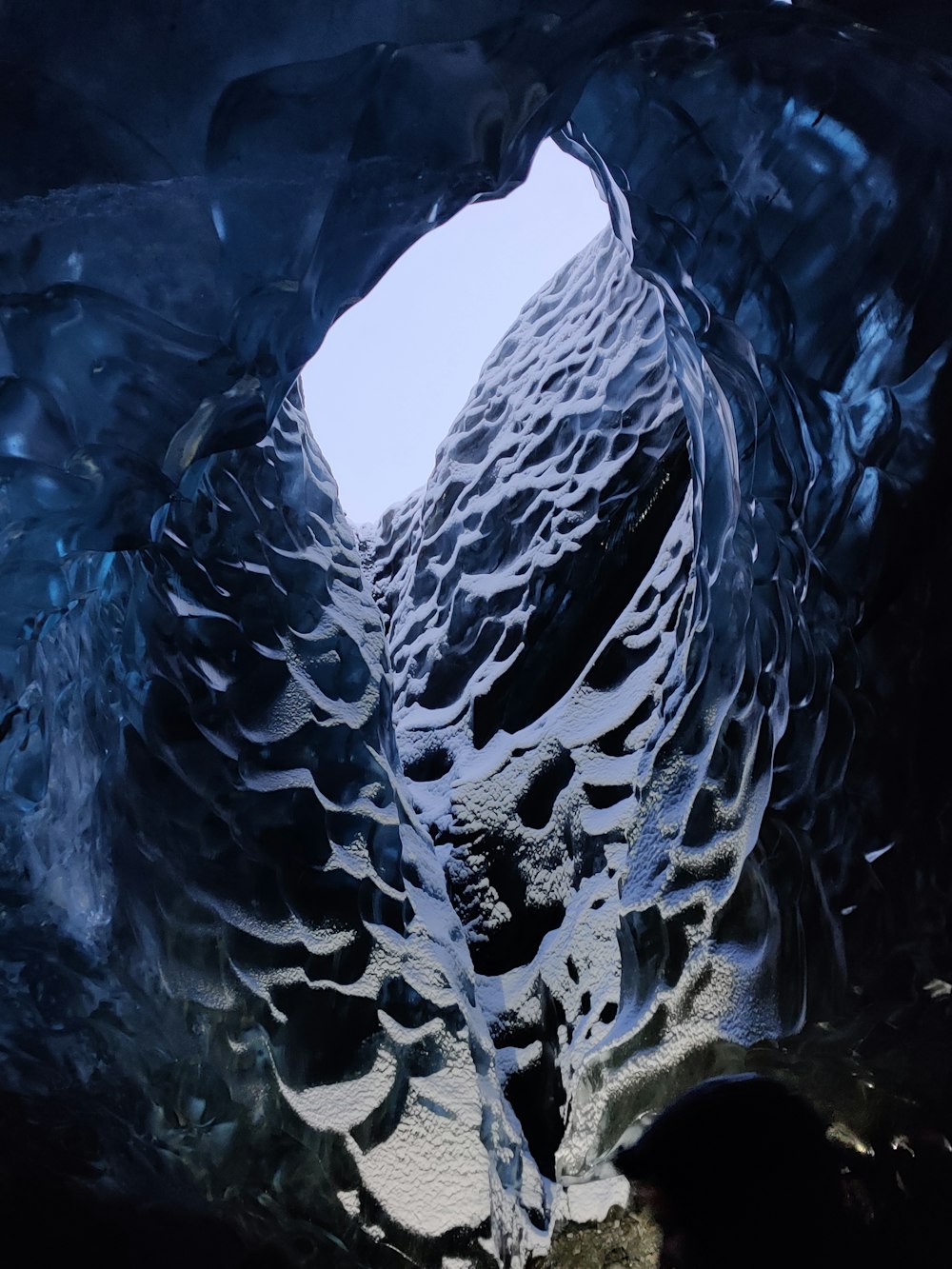 a man standing inside of an ice cave