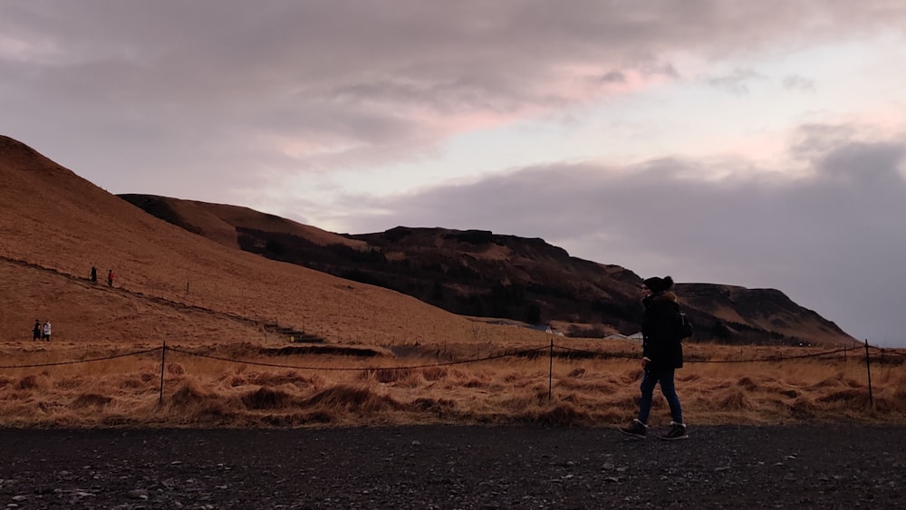 a man standing on the side of a road