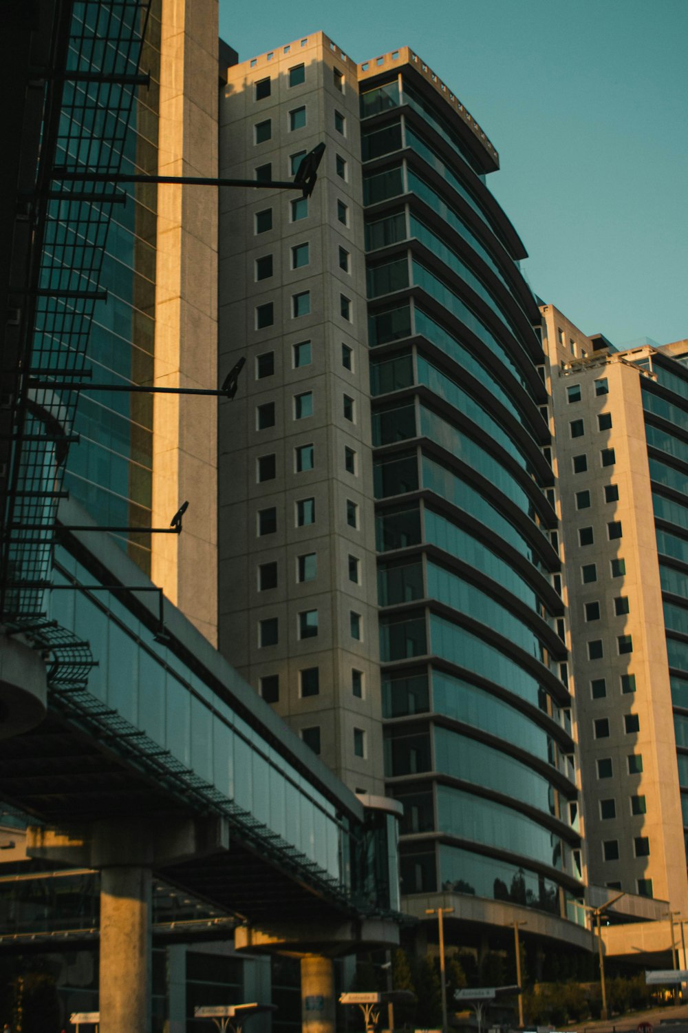 a tall building sitting next to a bridge