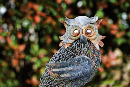 a statue of an owl holding a fish net