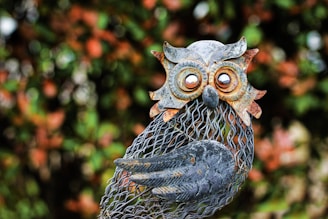 a statue of an owl holding a fish net
