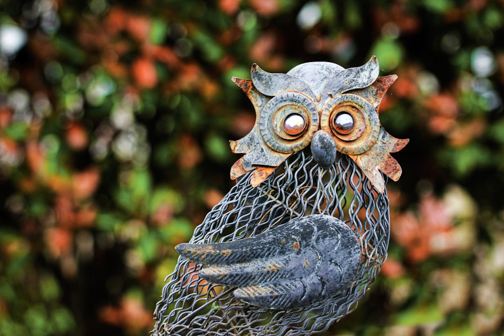 a statue of an owl holding a fish net