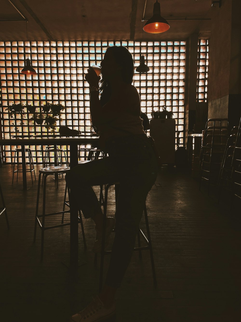 a person sitting at a table in a dark room