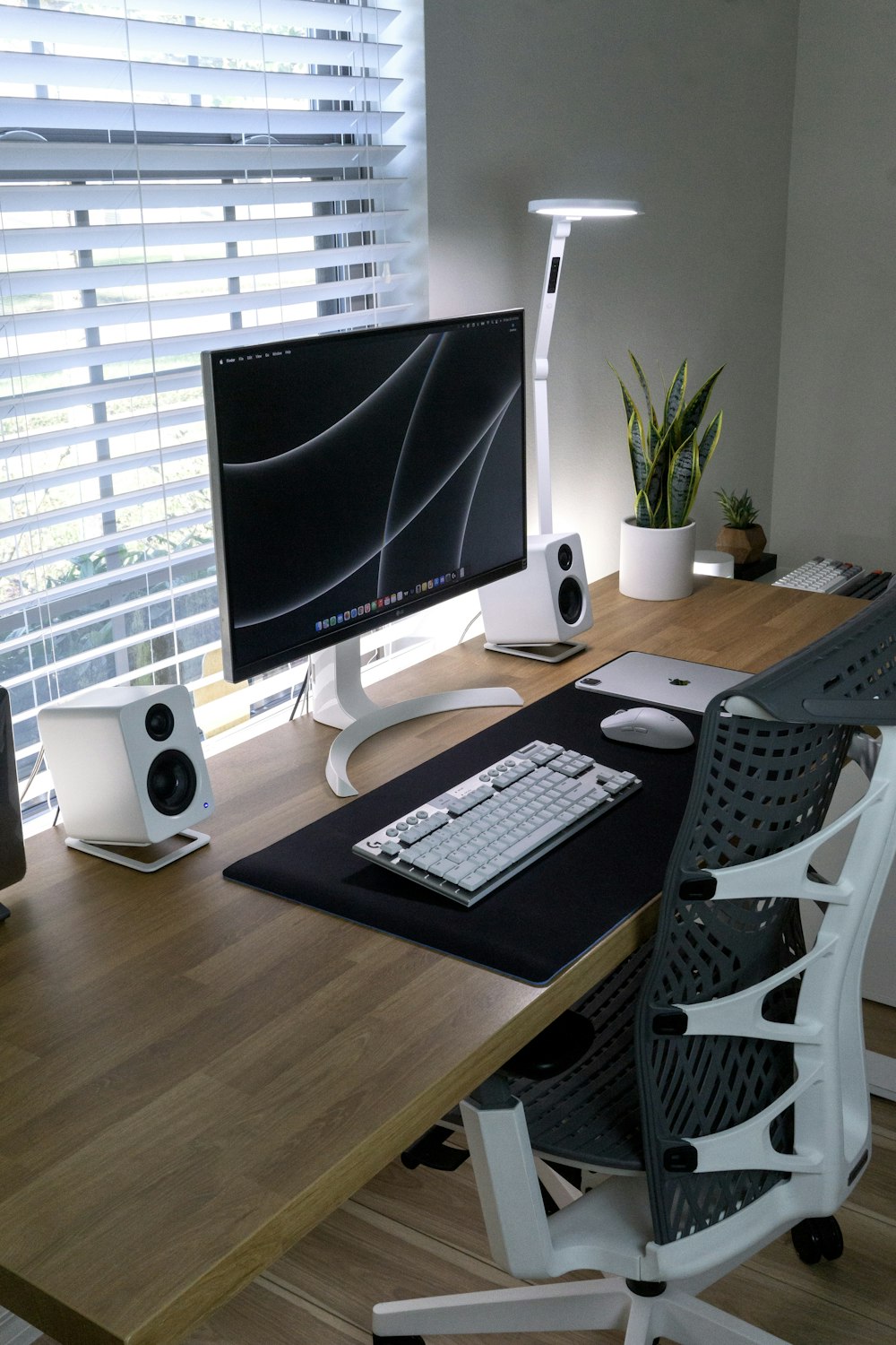 a desk with a computer and speakers on it