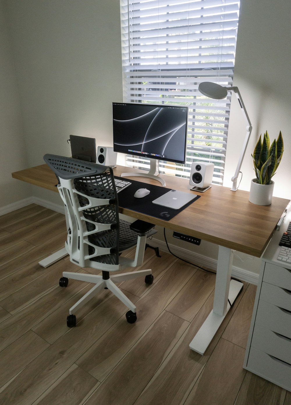 a desk with a computer on top of it