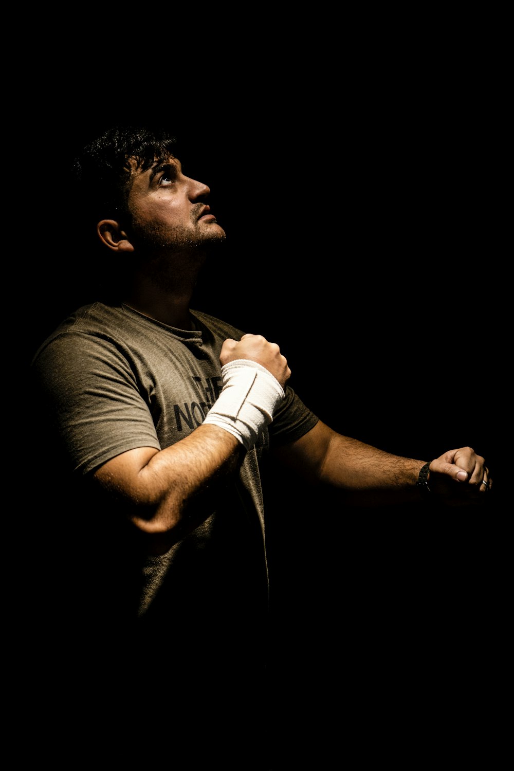 a man holding a tennis racquet on a black background