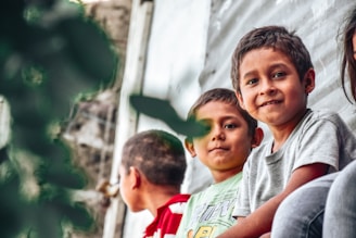 a group of young children sitting next to each other