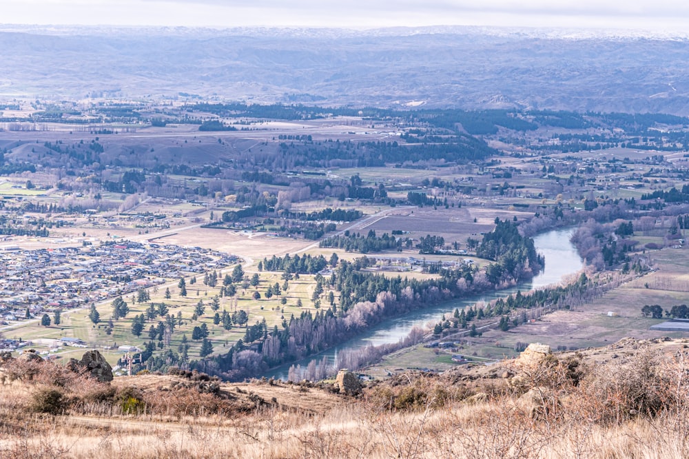 a view of a town and a river from a hill