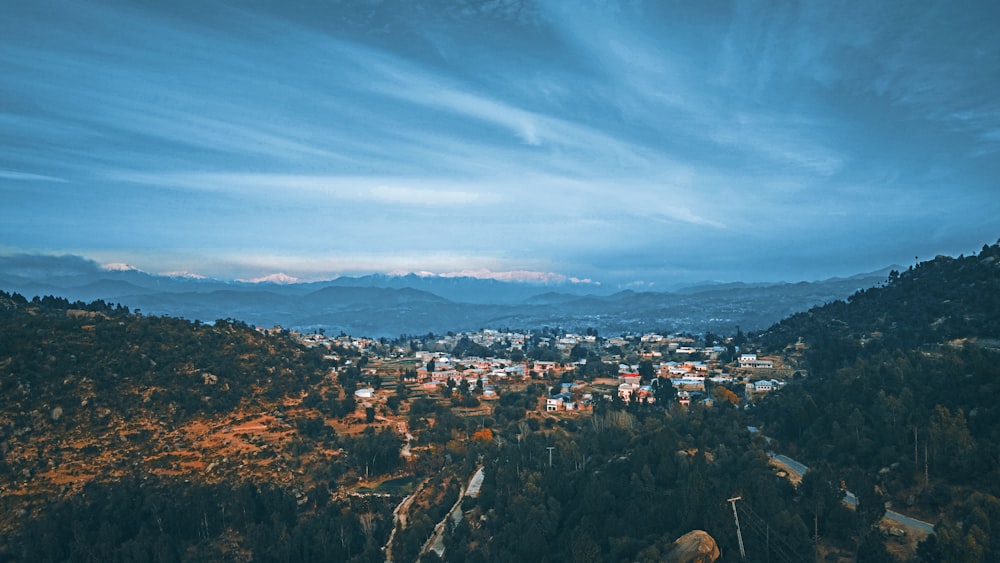 a scenic view of a town in the mountains